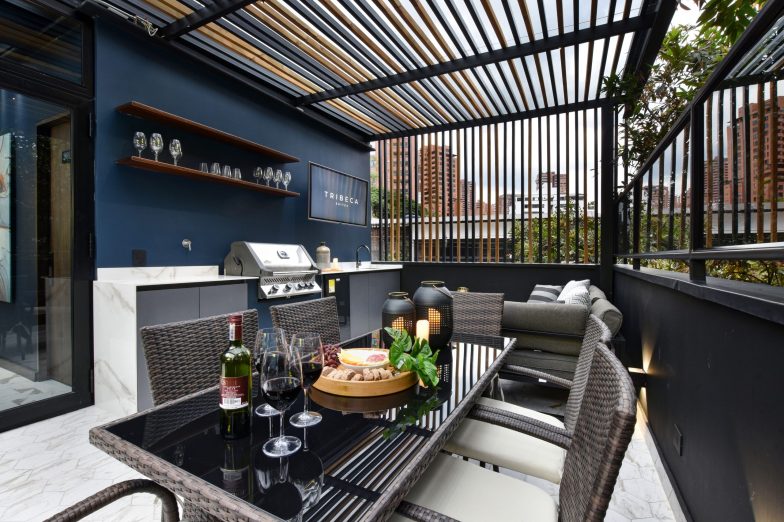 Dark toned patio with dining table and stylish decor