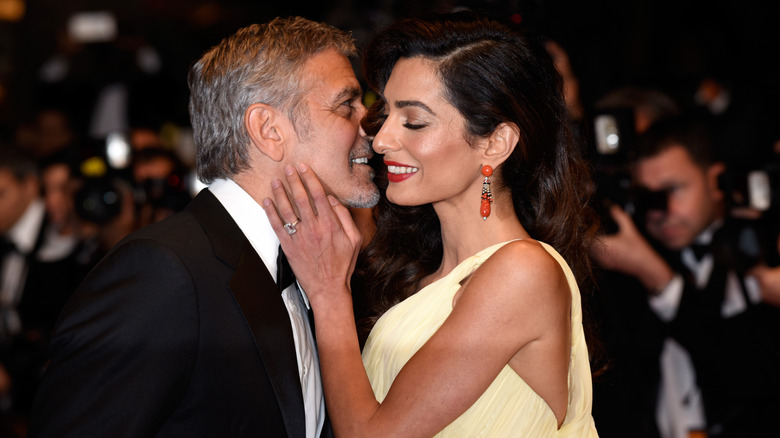 George Clooney kissing Amal Clooney