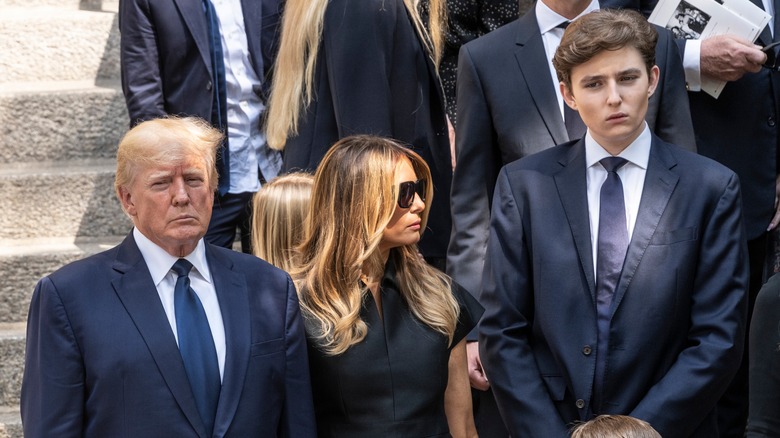 Donald, Melania, and Barron Trump solemn