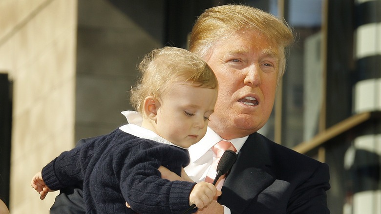 Donald Trump speaking, Barron Trump grabbing microphone