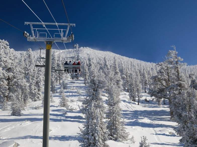 Skiers are riding lift on a very cold day at one of the Lake Tahoe ski resorts