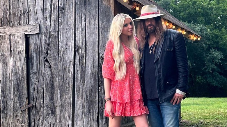 Billy Ray Cyrus and Firerose pose outside