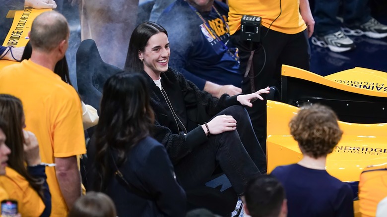 Caitlin Clark sitting at Indiana Pacers game