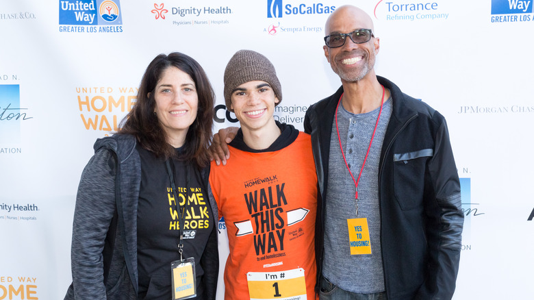 Cameron Boyce standing between his parents