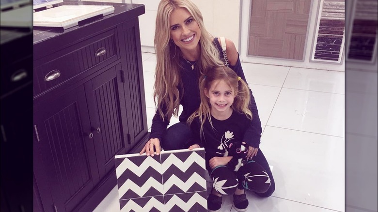 Christina Hall and daughter holding flooring