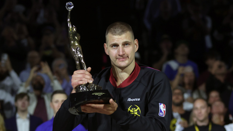 Nikola Jokic posing with the MVP trophy