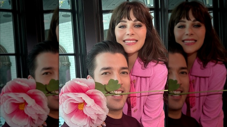 Zooey Deschanel smiling, Jonathan Scott with flower in mouth