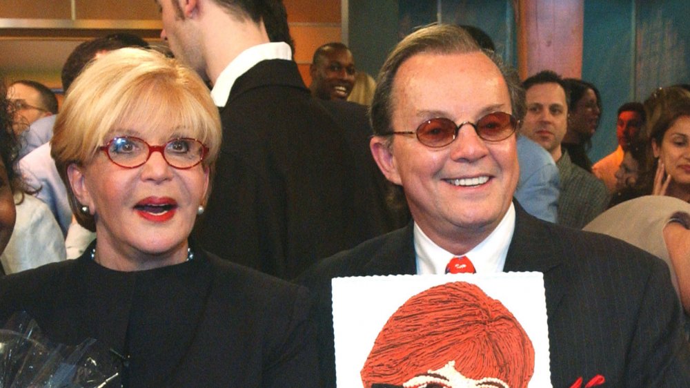 Talk show host Sally Jesse Raphael (L) and her husband Karl Soderlund prepare to cut her cake, celebrating the taping of her last show