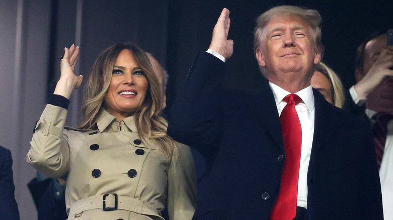 Donald and Melania Trump raising hands