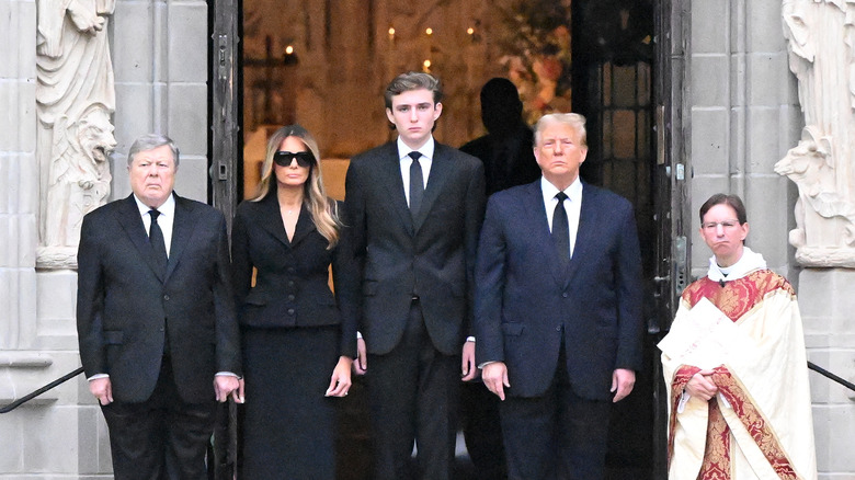 Barron Trump next to parents and grandfather