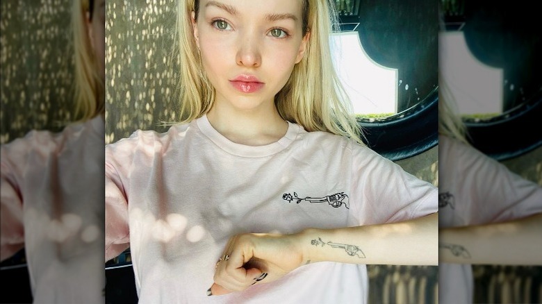 Dove Cameron showing her arm tattoo