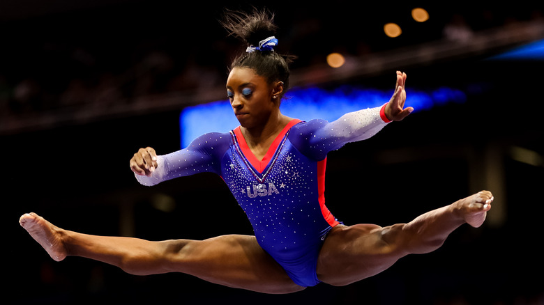 Simone Biles doing a split above the beam