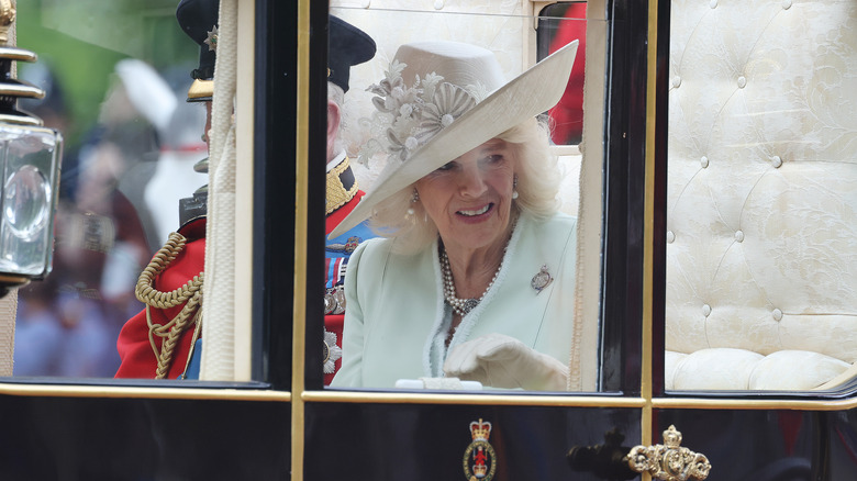 Queen Camilla wearing white hat