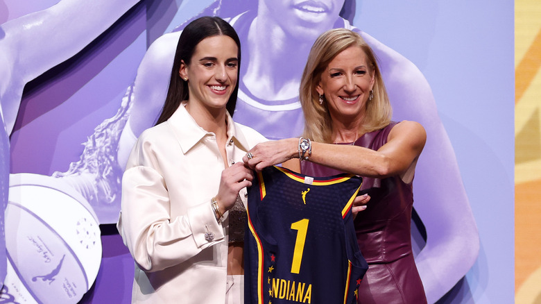 Caitlin Clark holds her Indiana Fever Jersey