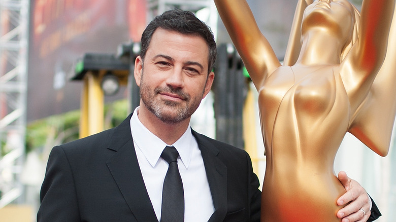 Jimmy Kimmel posing with Emmy statue