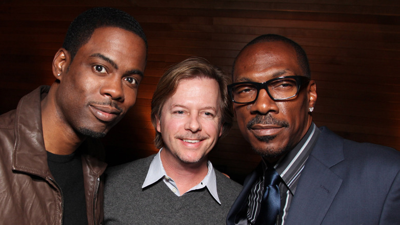 Chris Rock, David Spade, and Eddie Murphy posing for a selfie