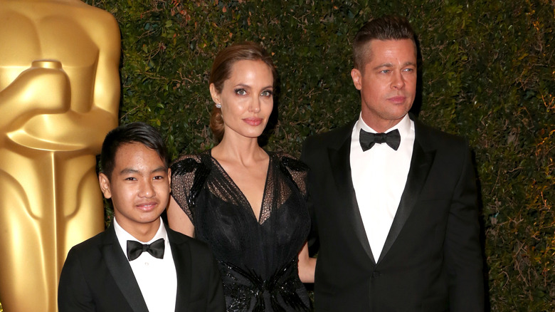 Brad Pitt poses with Maddox Jolie-Pitt and Angelina Jolie