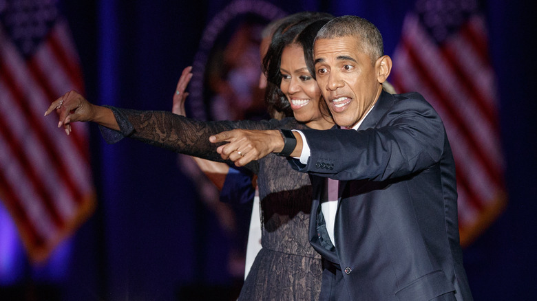 Michelle and Barack Obama pointing