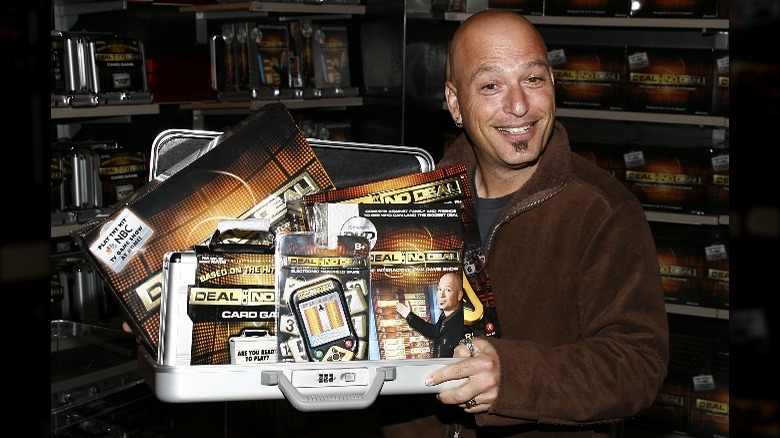 Howie Mandel posing with "Deal or No Deal" merch