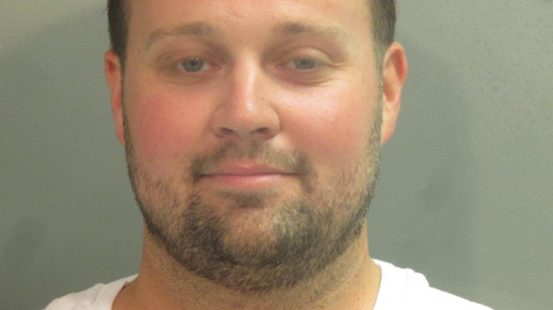 Josh Duggar smiling in mugshot