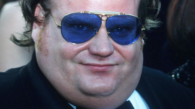 Chris Farley wearing sunglasses, smiling