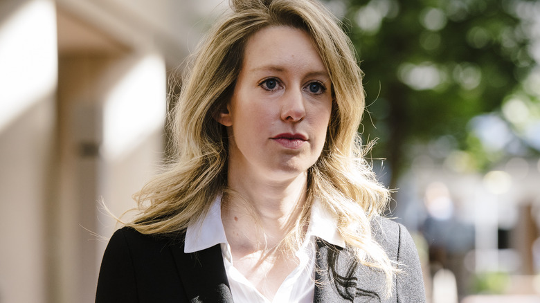 Elizabeth Holmes walks outdoors