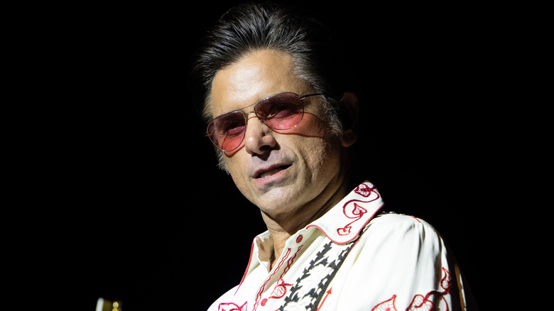 John Stamos wearing pink sunglasses