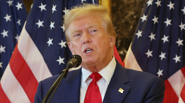 Donald Trump in front of American flags