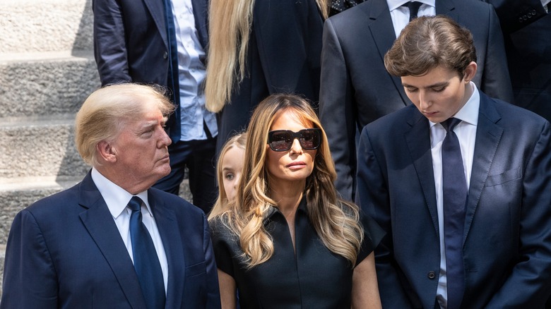 Donald, Melania, and Barron Trump at a funeral