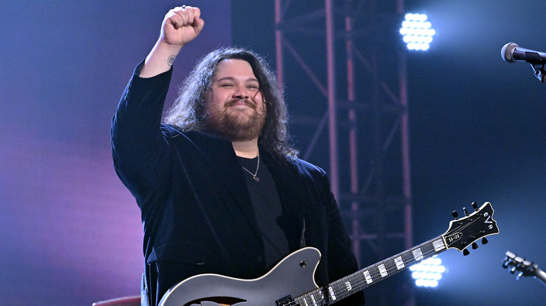 Wolfgang Van Halen raising his fist on stage