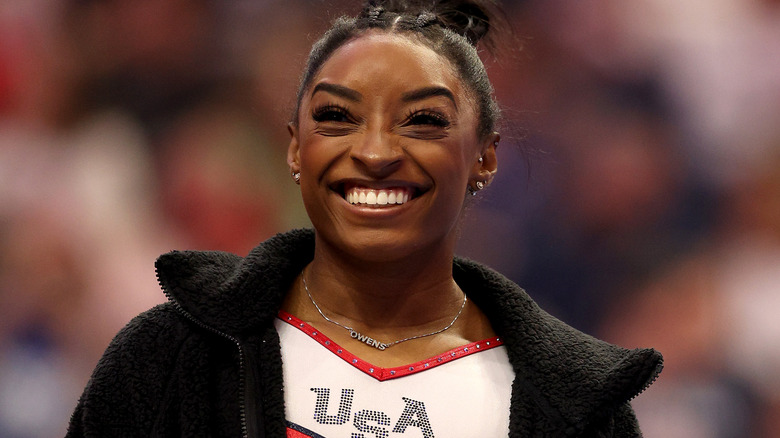 Simone Biles smiling in USA uniform