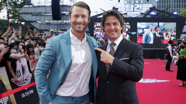 Glen Powell and Tom Cruise smiling