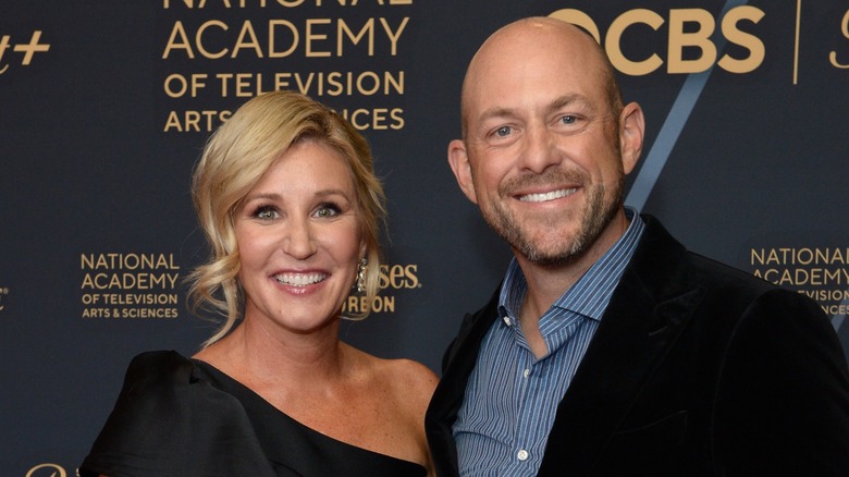 Jenny and Dave Marrs smiling on red carpet