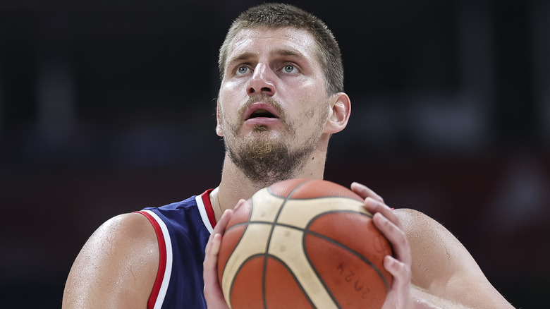 Nikola Jokic holding a basketball