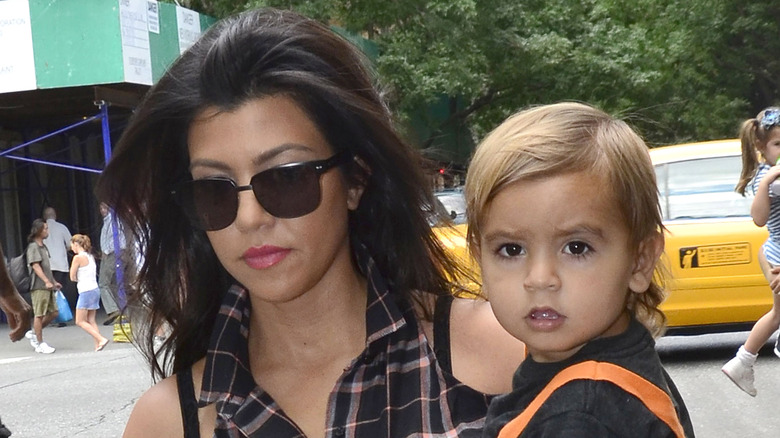 Kourtney Kardashian holding baby Mason Disick