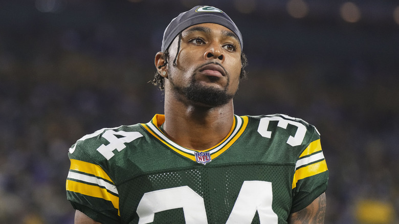 Jonathan Owens wearing a black cap and Green Bay Packers jersey and pads