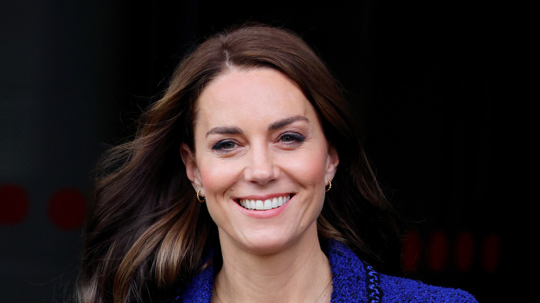 Kate Middleton smiling in blue suit