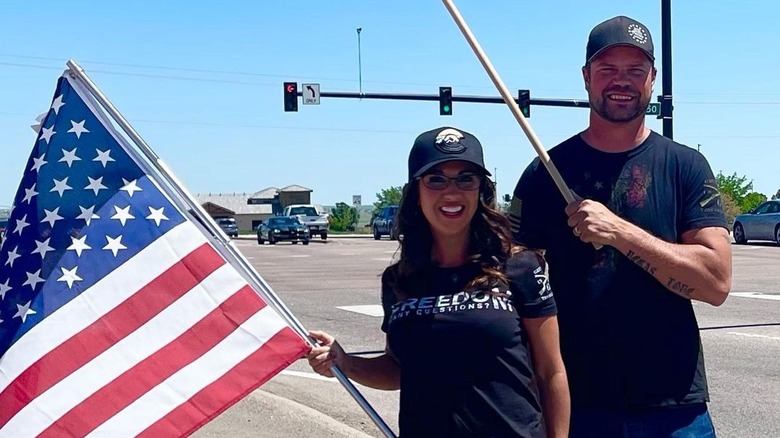 Lauren and Jayson Boebert pose with flags