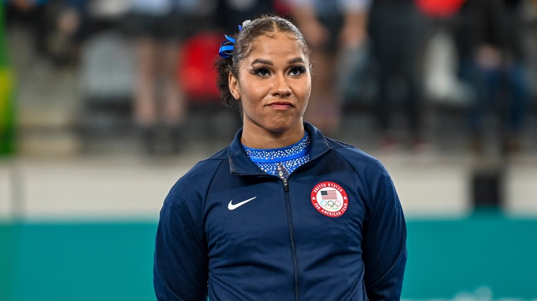 Jordan Chiles wearing a blue Nike jacket over a blue bedazzled shirt