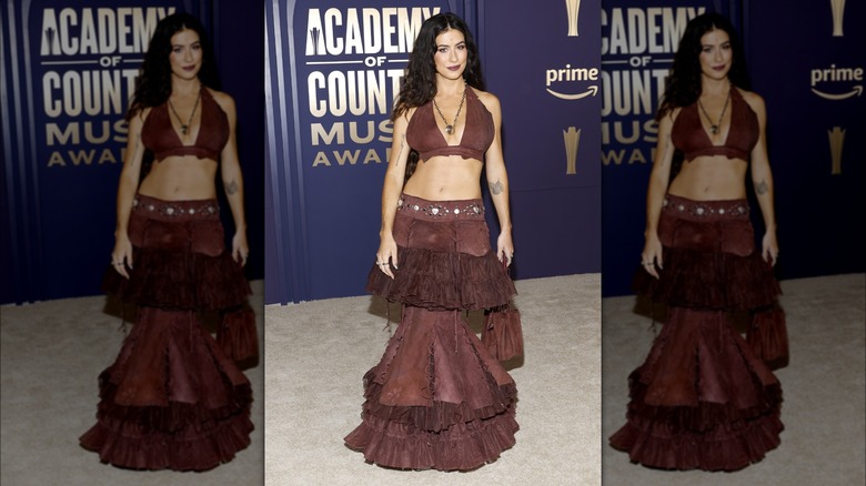 Kassie Ashton wearing brown crop top and skirt