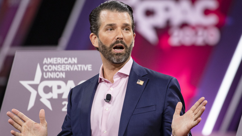 Donald Trump Jr. with hands raised