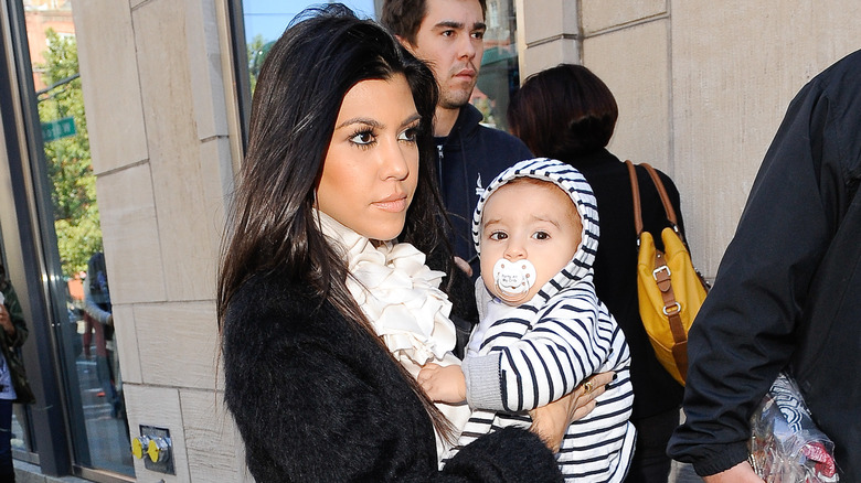 Kourtney Kardashian holding baby Mason