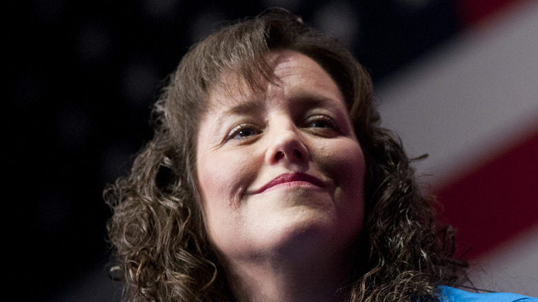 Michelle Duggar in front of flag