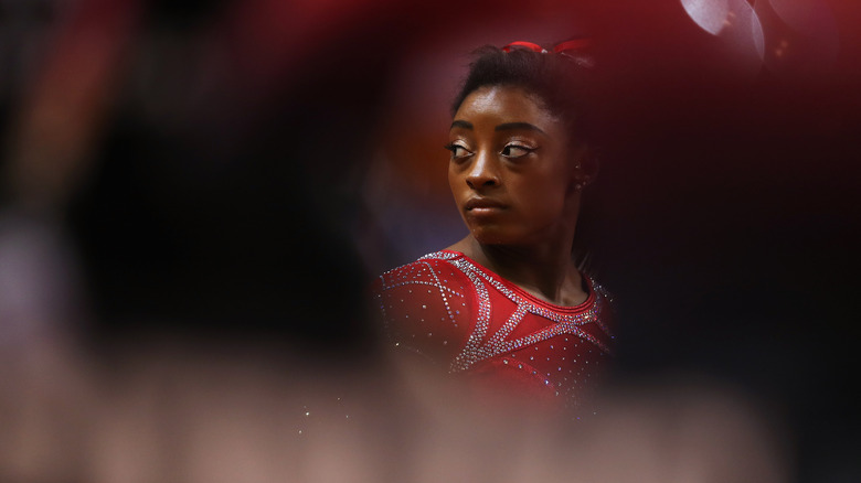 Simone Biles in a blurry environment