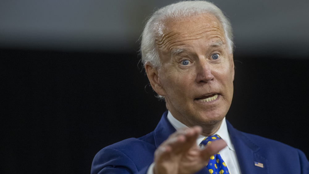 Joe Biden holding his hand out while speaking with a heated expression