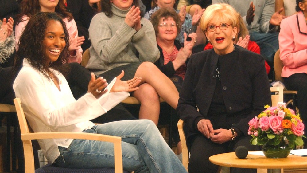 Talk show host Sally Jesse Raphael (R) speaks with her guest, singer Chilli from the group TLC during the taping of her last show