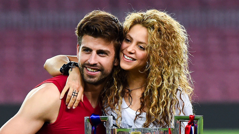 Shakira poses with her then-husband Gerard Pique on field