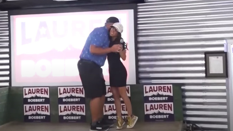 Lauren Boebert getting hug in gold sneakers