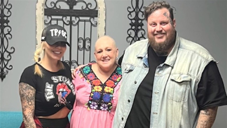 Jelly Roll and Bunnie Xo smiling with Suzanne Durham