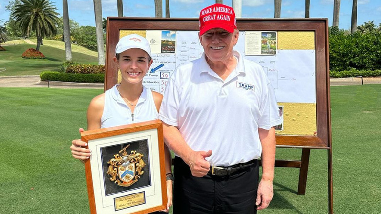 Kai Trump with Donald Trump on golf course